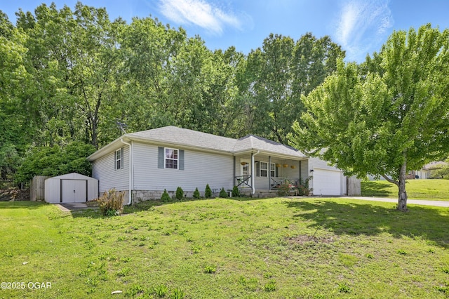 ranch-style house with covered porch, a storage unit, a front lawn, and an outbuilding