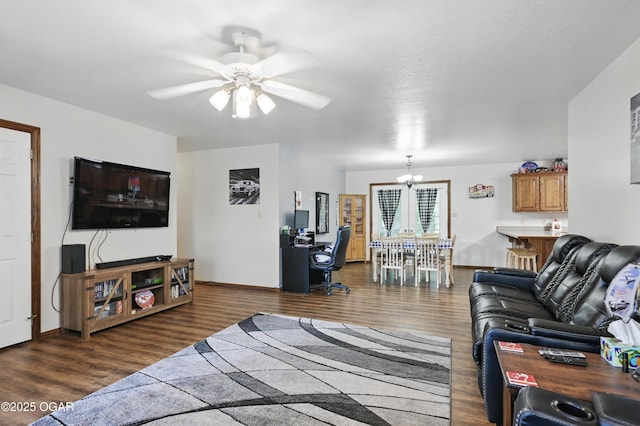 living room featuring a chandelier, a ceiling fan, wood finished floors, and baseboards