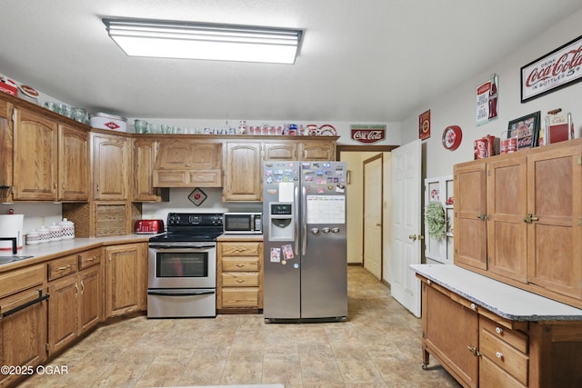 kitchen featuring appliances with stainless steel finishes, premium range hood, brown cabinetry, and light countertops