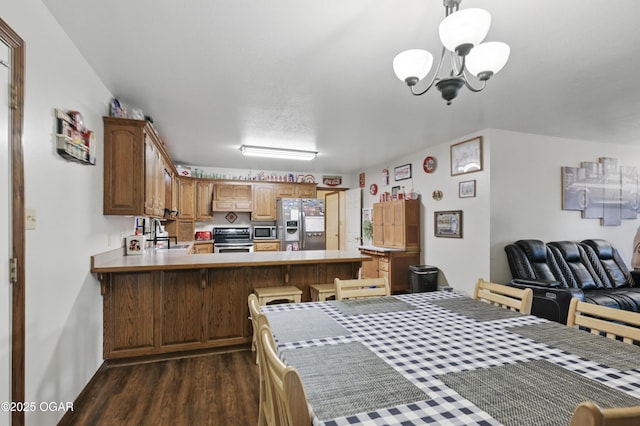 dining area with dark wood-type flooring and a chandelier