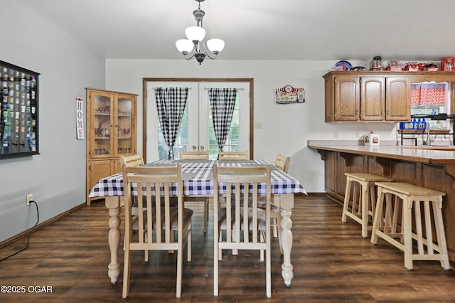 dining room featuring dark wood-style floors, french doors, and baseboards