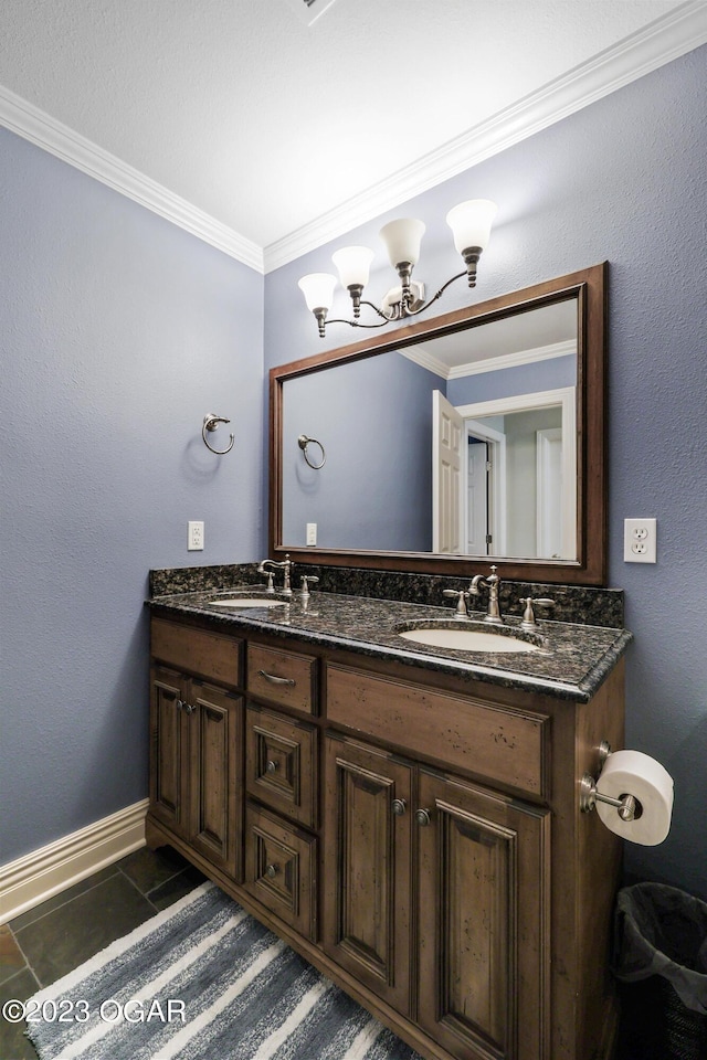 full bath featuring crown molding, baseboards, double vanity, and a chandelier