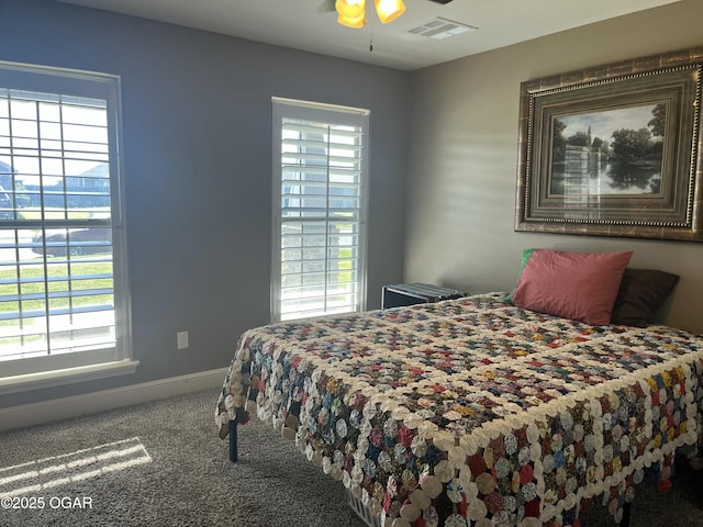 bedroom with carpet, multiple windows, and baseboards