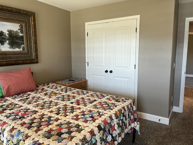 bedroom with carpet floors, a closet, and baseboards