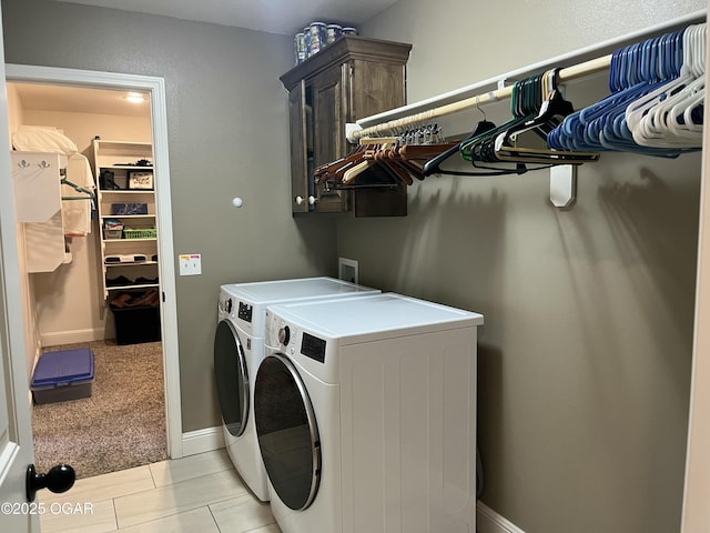 laundry area with separate washer and dryer, cabinet space, and baseboards