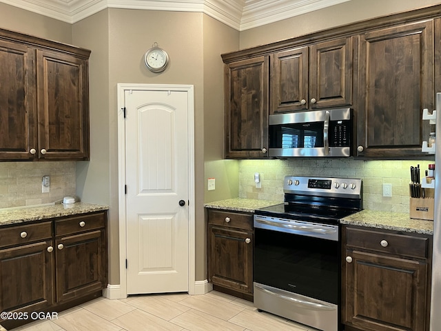 kitchen with stainless steel appliances, crown molding, dark brown cabinetry, decorative backsplash, and light stone countertops