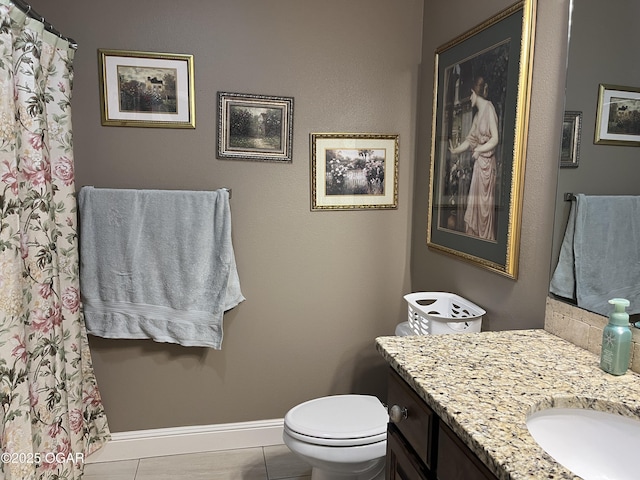 full bathroom featuring baseboards, vanity, toilet, and tile patterned floors