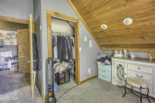 walk in closet with vaulted ceiling and carpet flooring
