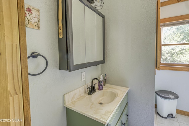 bathroom with vanity, tile patterned floors, and baseboards
