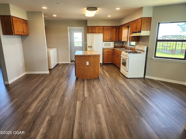208 NW 10th Rd, Lamar, MO 64759 - kitchen featuring white appliances, a sink, under cabinet range hood, a center island, and baseboards