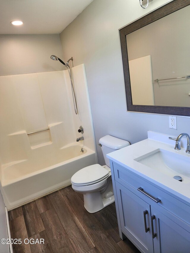 208 NW 10th Rd, Lamar, MO 64759 - bathroom featuring toilet, wood finished floors, bathtub / shower combination, vanity, and recessed lighting