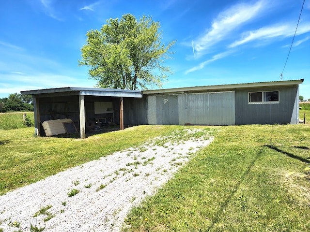 208 NW 10th Rd, Lamar, MO 64759 - back of house with a lawn, a carport, and a pole building