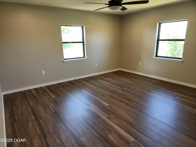 208 NW 10th Rd, Lamar, MO 64759 - spare room featuring a ceiling fan, dark wood-style floors, and baseboards