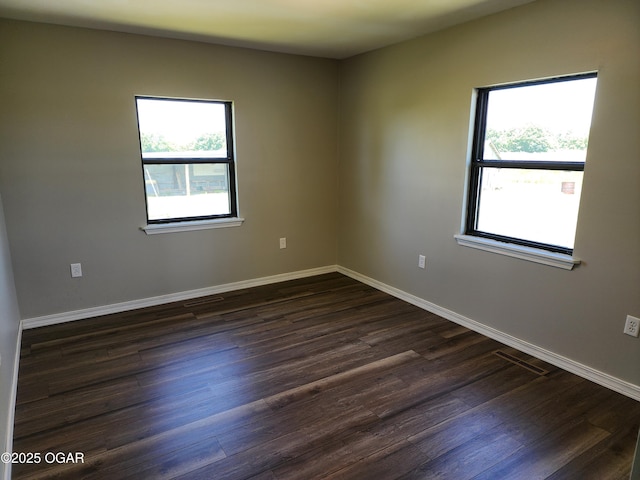208 NW 10th Rd, Lamar, MO 64759 - empty room featuring dark wood-type flooring and baseboards