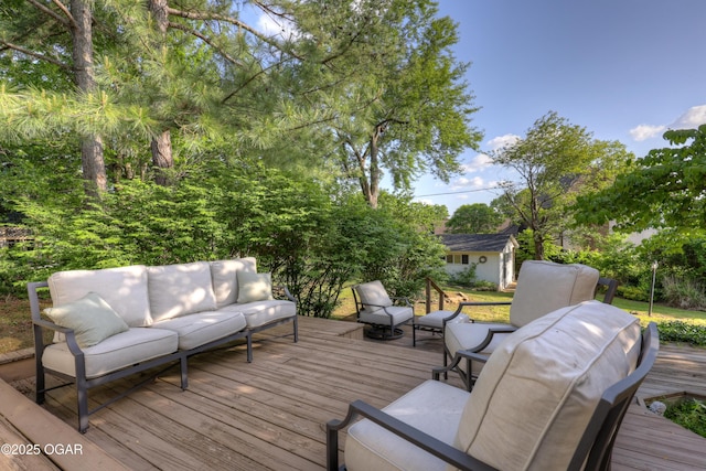 deck featuring an outdoor living space and an outdoor structure