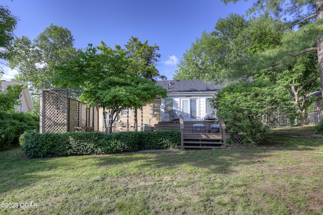 back of property featuring a yard and a wooden deck