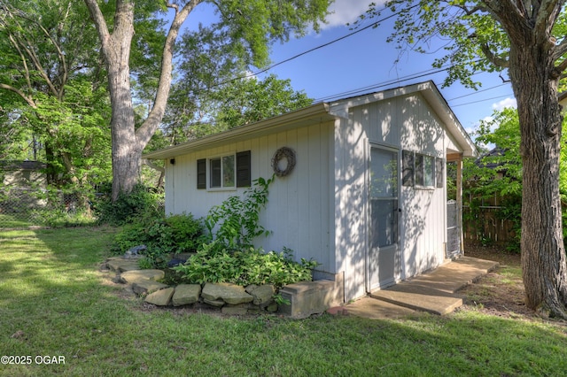 view of side of home featuring an outbuilding