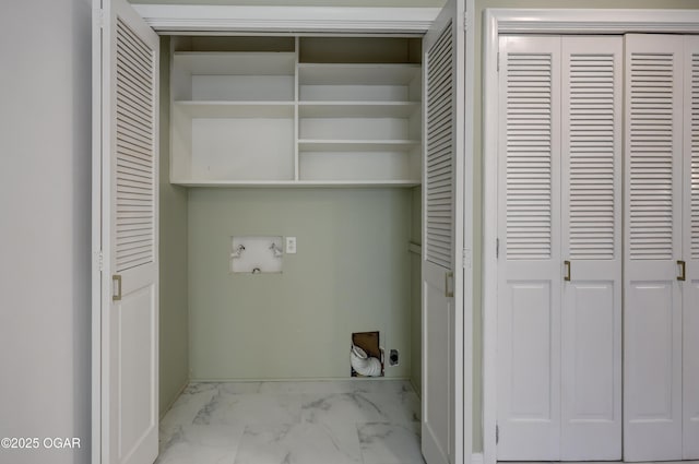 clothes washing area featuring hookup for an electric dryer, marble finish floors, and washer hookup