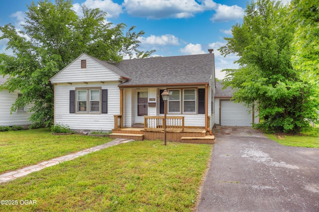 bungalow-style house featuring a porch, driveway, a shingled roof, and a front yard