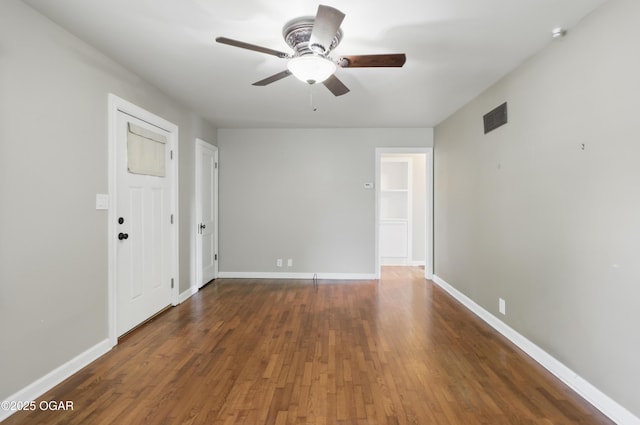 spare room with ceiling fan, wood finished floors, and baseboards