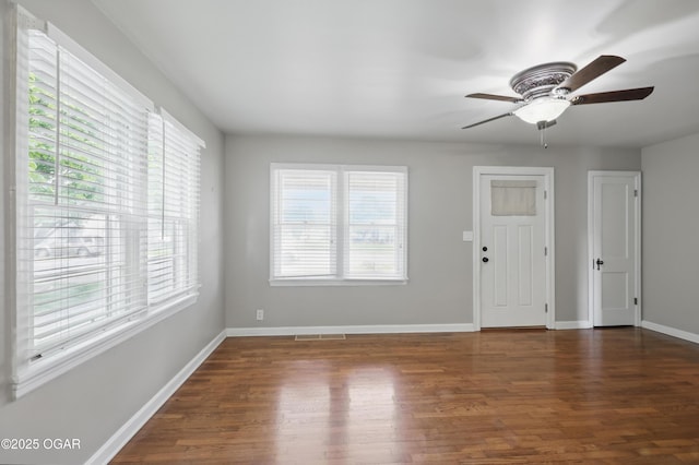 foyer entrance with wood finished floors, a ceiling fan, and baseboards