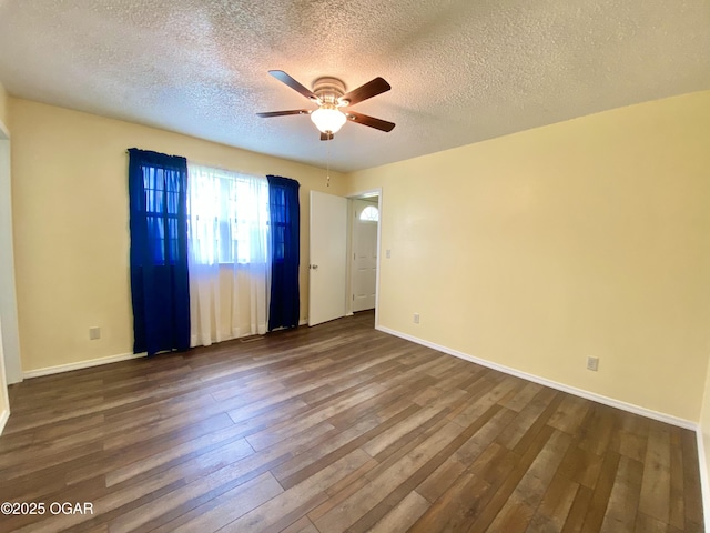 21522 Old Ritchey Rd, Granby, MO 64844 - unfurnished room featuring ceiling fan, dark wood-style flooring, a textured ceiling, and baseboards