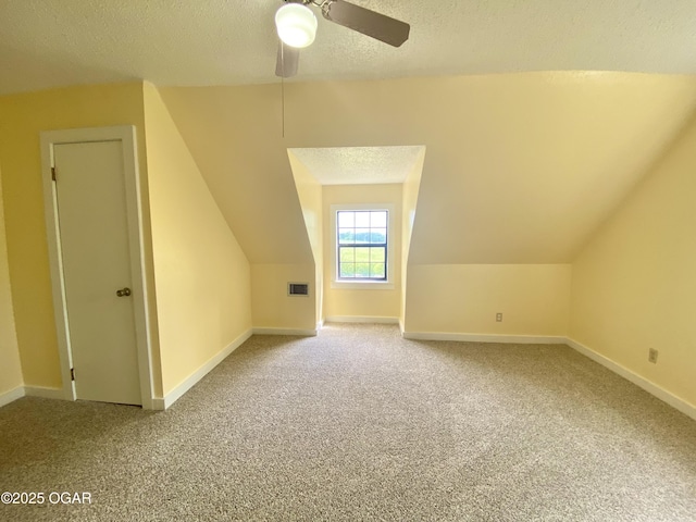 21522 Old Ritchey Rd, Granby, MO 64844 - additional living space featuring a textured ceiling, carpet flooring, vaulted ceiling, ceiling fan, and baseboards