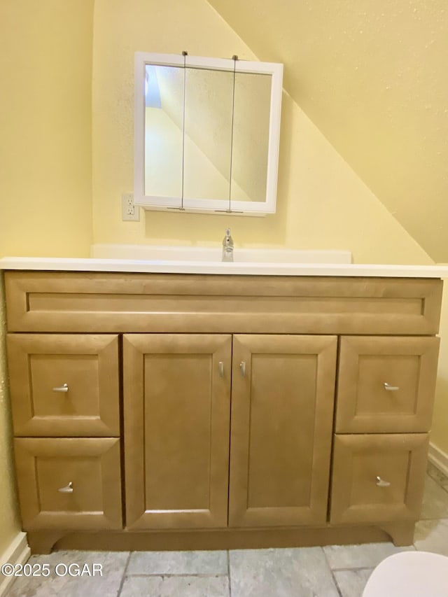 21522 Old Ritchey Rd, Granby, MO 64844 - bathroom with vaulted ceiling, vanity, and baseboards