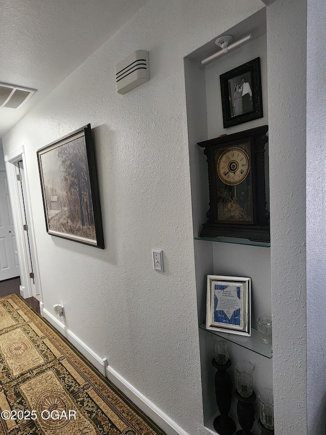 600 W Mercer, Jasper, MO 64755 - hallway featuring baseboards, a textured wall, and wood finished floors