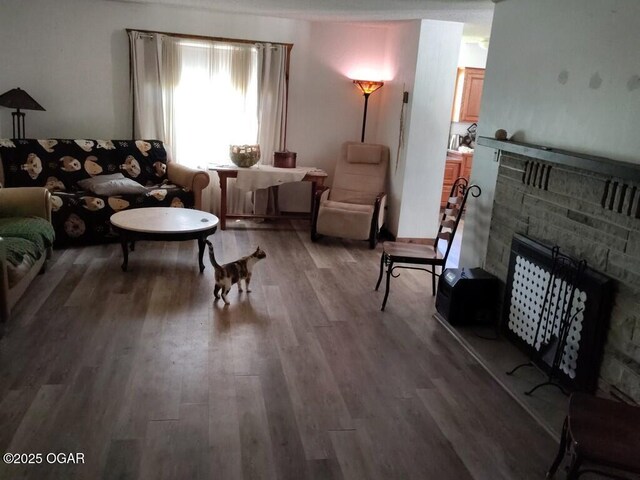 6468 Dogwood Rd, Reeds, MO 64859 - living room featuring a fireplace with raised hearth and wood finished floors