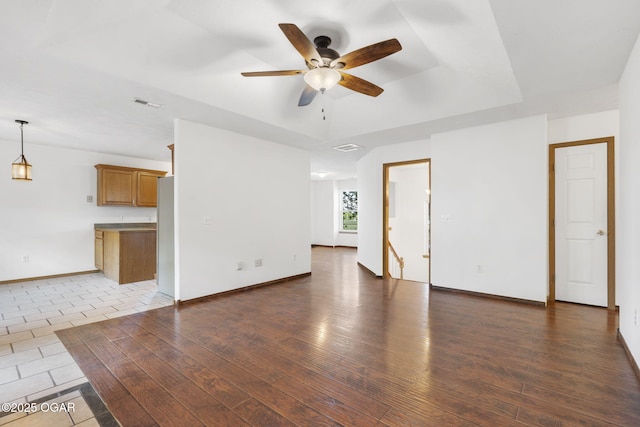 9969 Lawrence Unit 2222, Monett, MO 65708 - unfurnished living room featuring ceiling fan, wood finished floors, and baseboards