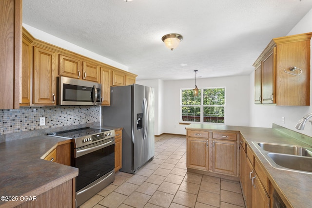9969 Lawrence Unit 2222, Monett, MO 65708 - kitchen featuring appliances with stainless steel finishes, a sink, a peninsula, decorative backsplash, and light tile patterned floors