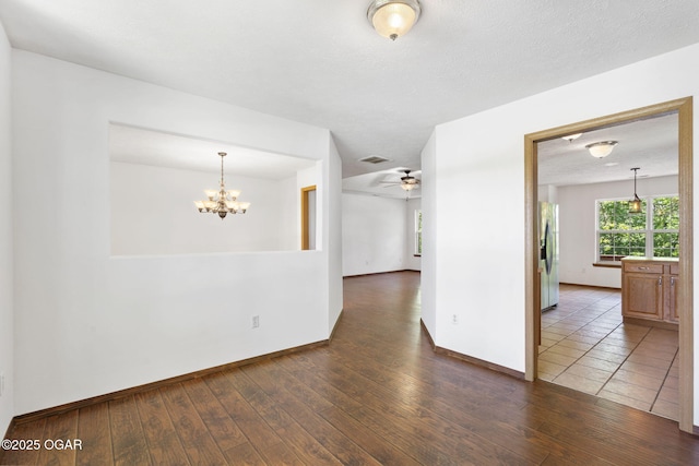 9969 Lawrence Unit 2222, Monett, MO 65708 - spare room with wood-type flooring, a chandelier, baseboards, and a ceiling fan