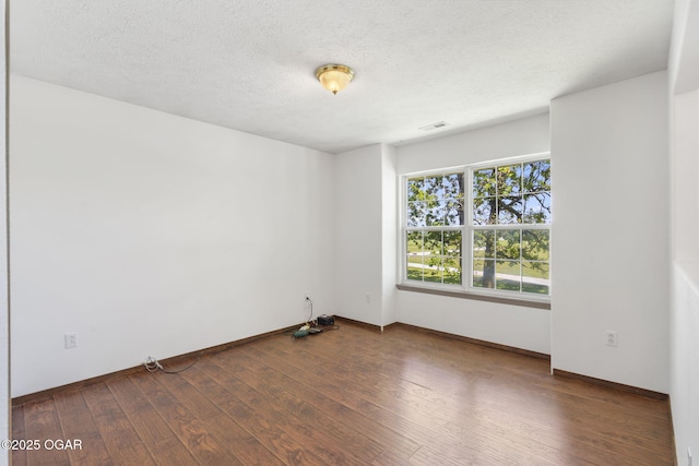 9969 Lawrence Unit 2222, Monett, MO 65708 - empty room with wood-type flooring, baseboards, and a textured ceiling
