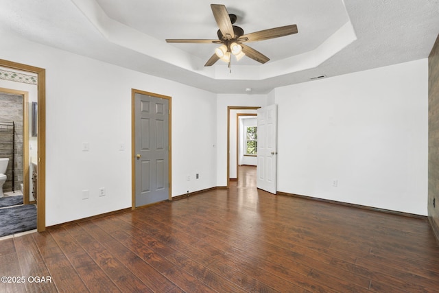 9969 Lawrence Unit 2222, Monett, MO 65708 - unfurnished bedroom with a raised ceiling, baseboards, wood finished floors, and ceiling fan