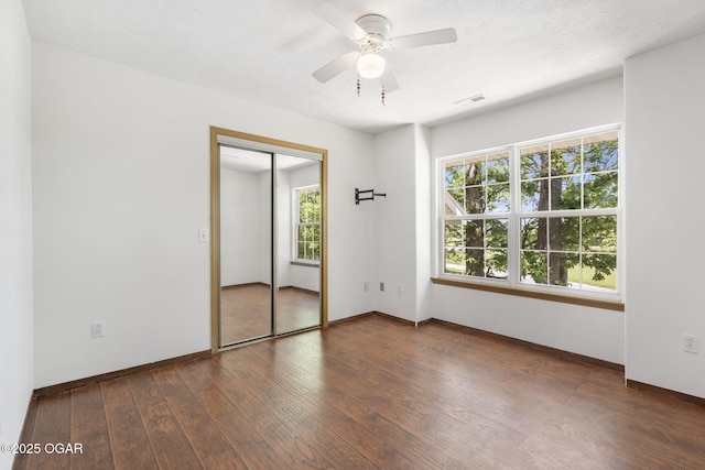 9969 Lawrence Unit 2222, Monett, MO 65708 - unfurnished bedroom with wood finished floors, baseboards, a closet, and ceiling fan