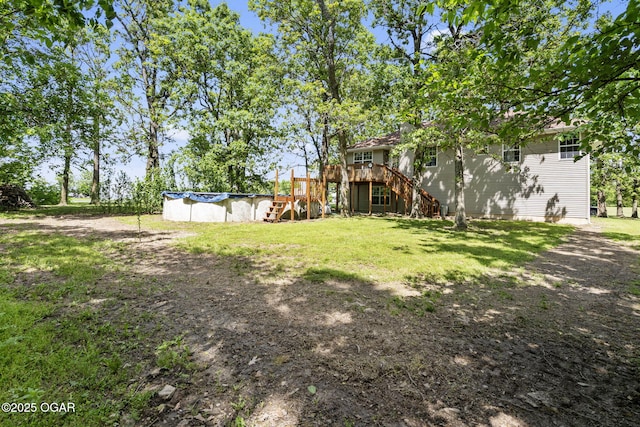 9969 Lawrence Unit 2222, Monett, MO 65708 - view of green lawn with stairway, a wooden deck, and a covered pool