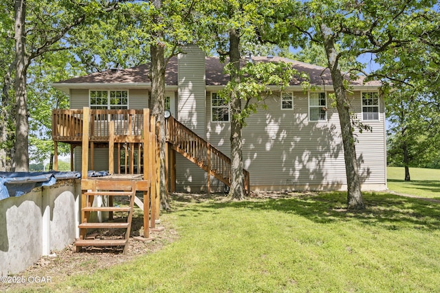 9969 Lawrence Unit 2222, Monett, MO 65708 - rear view of property featuring a wooden deck, stairway, a chimney, a lawn, and roof with shingles