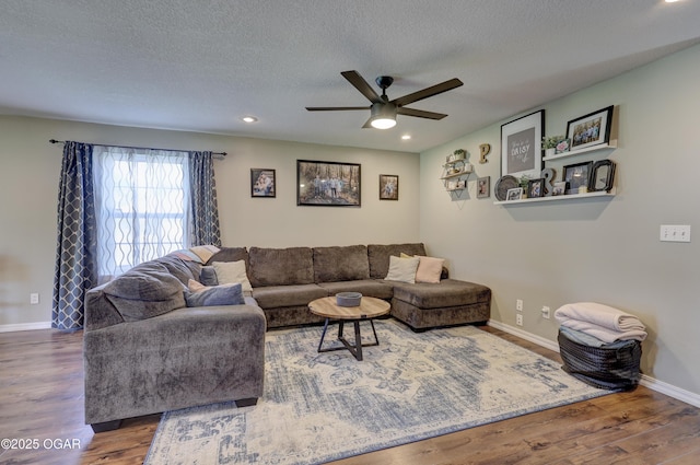 living room with ceiling fan, wood finished floors, recessed lighting, baseboards, and a textured ceiling