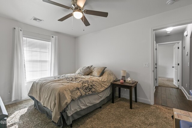 carpeted bedroom with baseboards and a ceiling fan