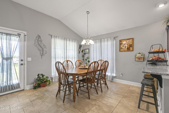 dining space with lofted ceiling, a chandelier, baseboards, and light tile patterned floors