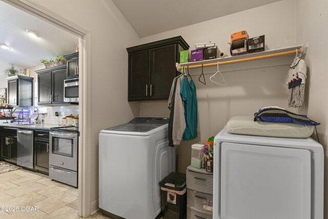laundry area with washer and dryer and cabinet space