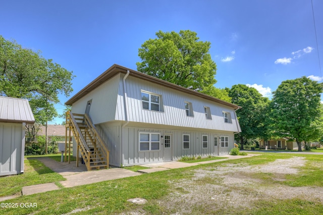 238 E 21st St, Baxter Springs, KS 66713 - rear view of property featuring stairs and board and batten siding