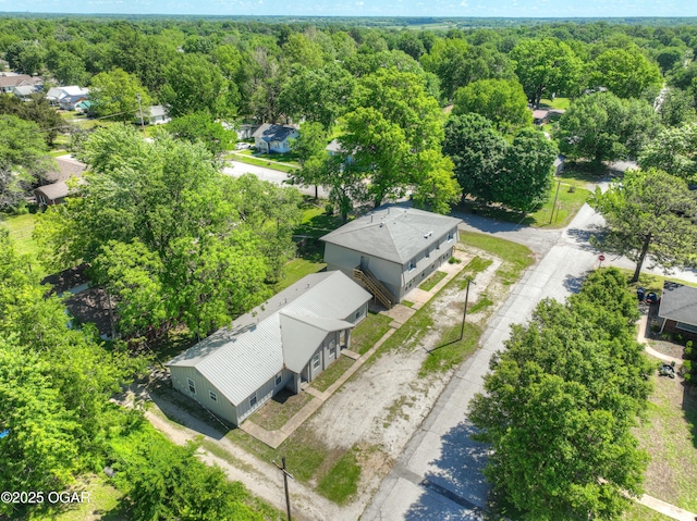 238 E 21st St, Baxter Springs, KS 66713 - aerial perspective of suburban area featuring a heavily wooded area