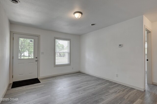 238 E 21st St, Baxter Springs, KS 66713 - foyer featuring light wood-style flooring and baseboards