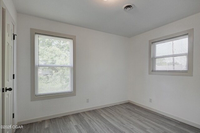 238 E 21st St, Baxter Springs, KS 66713 - unfurnished room featuring plenty of natural light, light wood-style flooring, and baseboards