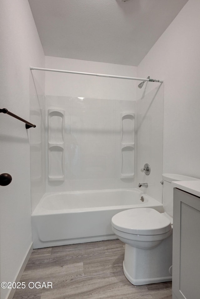 238 E 21st St, Baxter Springs, KS 66713 - bathroom featuring wood finished floors, toilet, tub / shower combination, and vanity