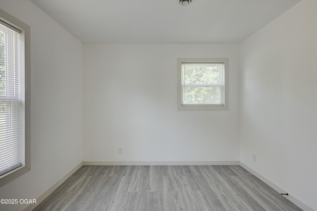 238 E 21st St, Baxter Springs, KS 66713 - empty room with light wood-style floors and baseboards