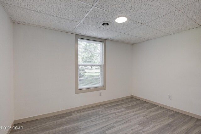 238 E 21st St, Baxter Springs, KS 66713 - spare room with wood finished floors, a drop ceiling, and baseboards