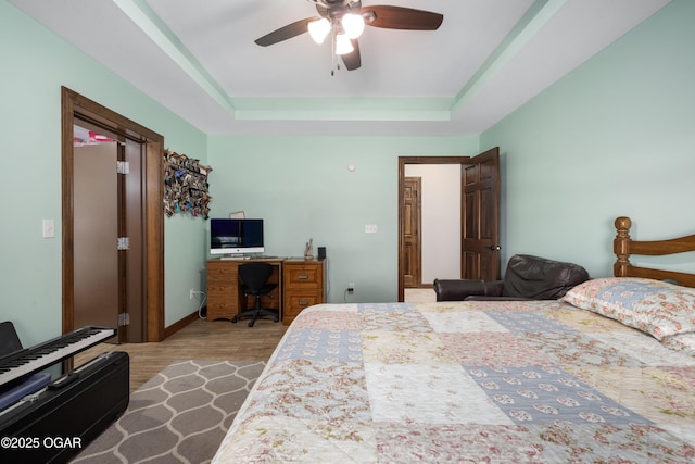 12244 County Rd 227, Oronogo, MO 64855 - bedroom featuring a raised ceiling, an office area, wood finished floors, and a ceiling fan